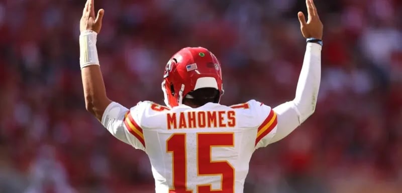 Patrick Mahomes raising his arms in victory, symbolizing how brands leverage Beatgrid’s cross-media measurement tools to capture and engage diverse audiences across multiple platforms.