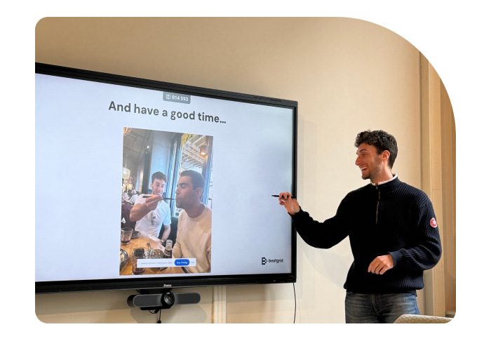 Ian Hobkirk, Beatgrid's Marketing Manager enthusiastically explaining a slide with the text "And have a good time..." on a large screen.