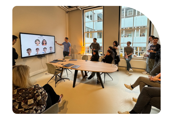 Team members attentively watching a presentation on character sketches in a modern office setting.